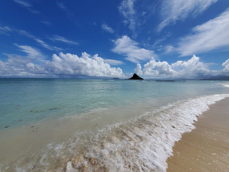 Ocean panorama with soft surf on a wide beach