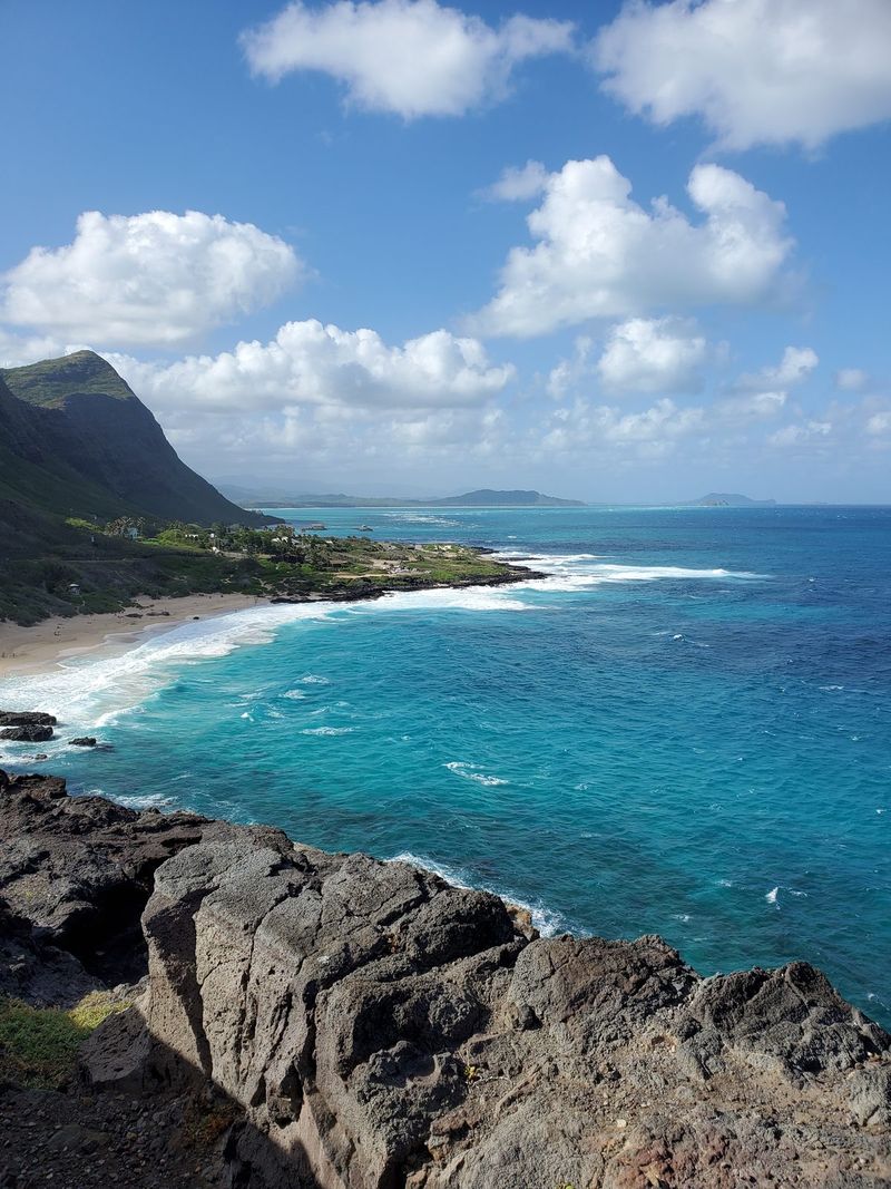 Wide beach panorama with foam-lined turquoise water